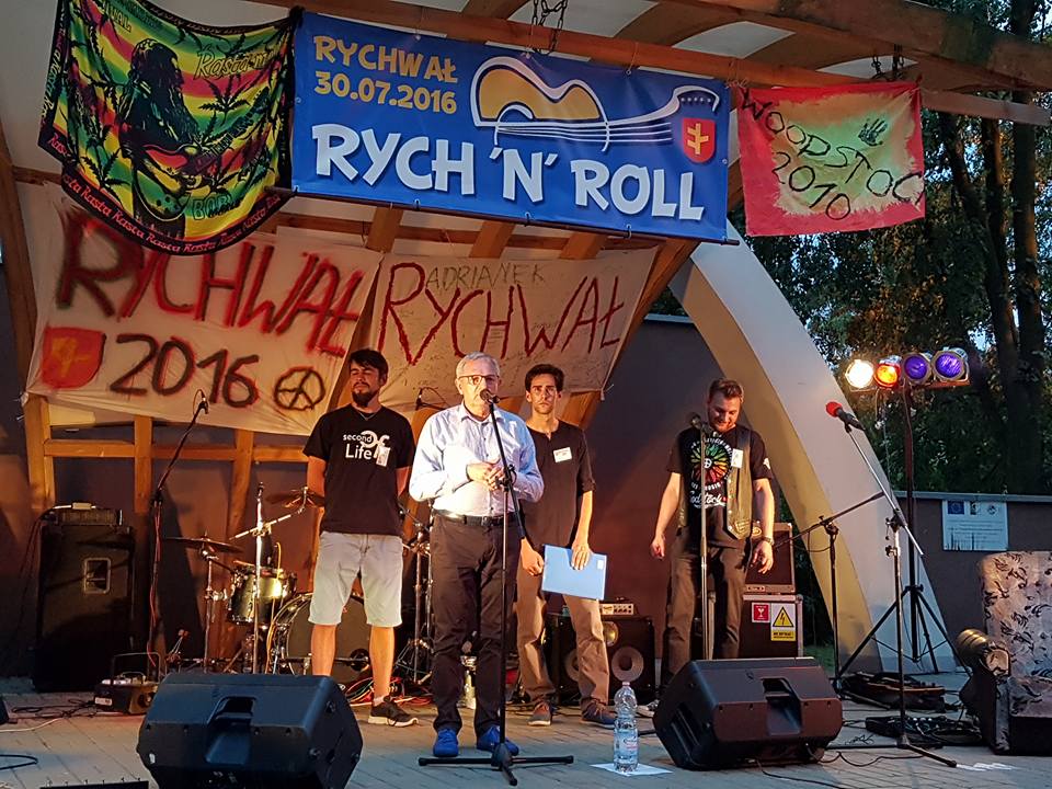 II Festiwal Muzyczny Rych n, Roll_1: zdjęcie przedstawia mężczyznę przy mikrofonie w tle trzech mężczyzn