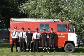 Rychwalia 2012: Zdjęcie przedstawia sześciu strażaków na tle wozu strażackiego. 